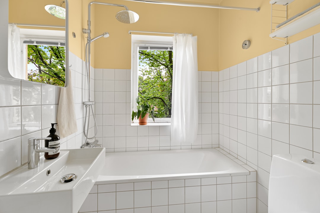 A bathroom with a tub, sink, and toilet