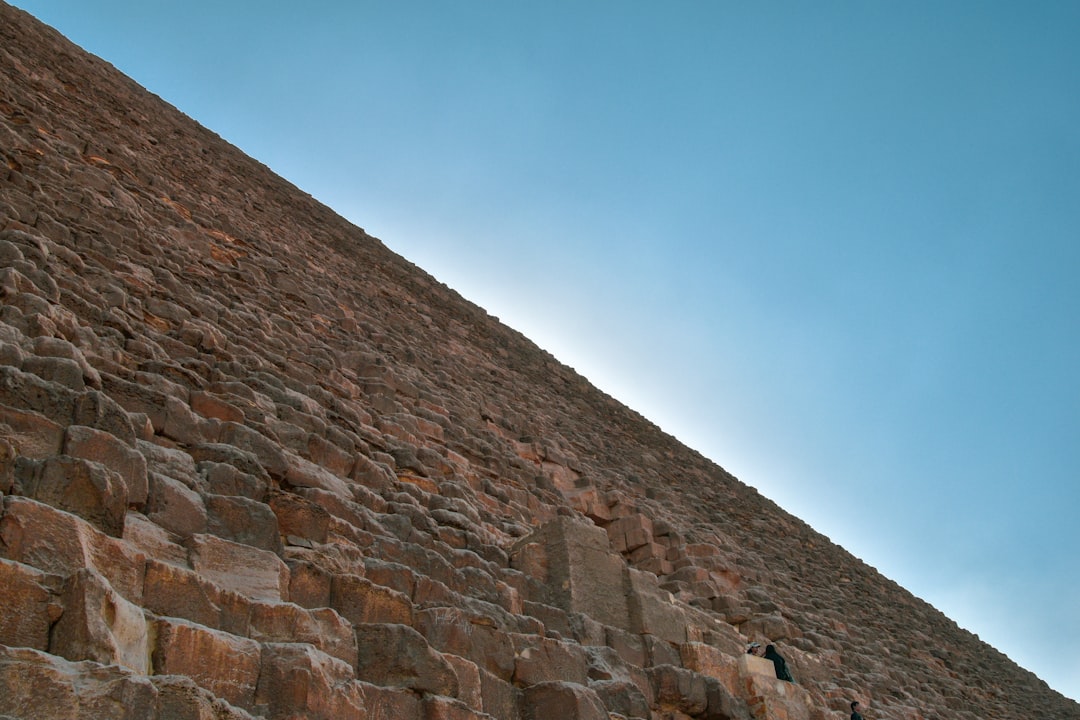 brown brick wall under blue sky during daytime