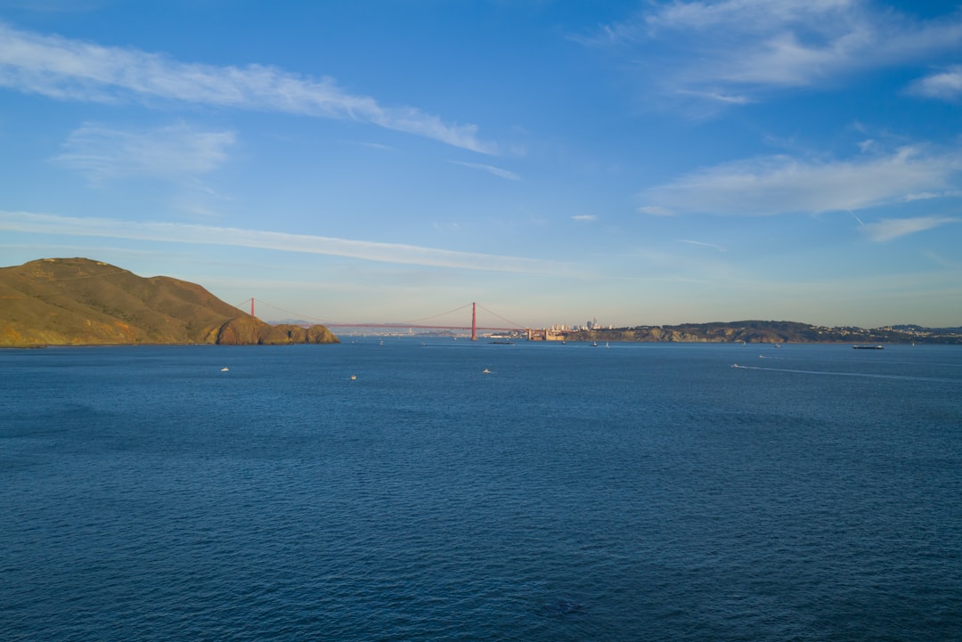 a large body of water with a bridge in the background