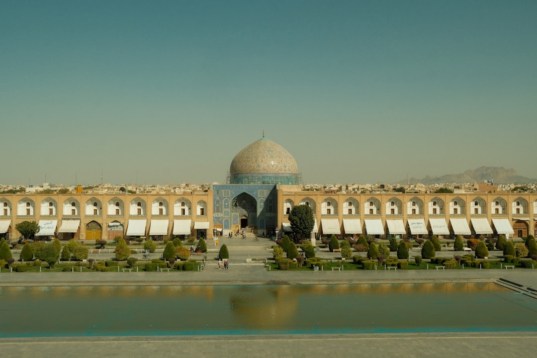 Grand mosque with a dome and reflecting pool.