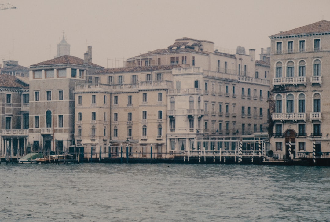 Historic buildings line a canal in venice.