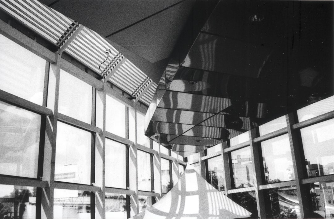grayscale photo of framed glass building