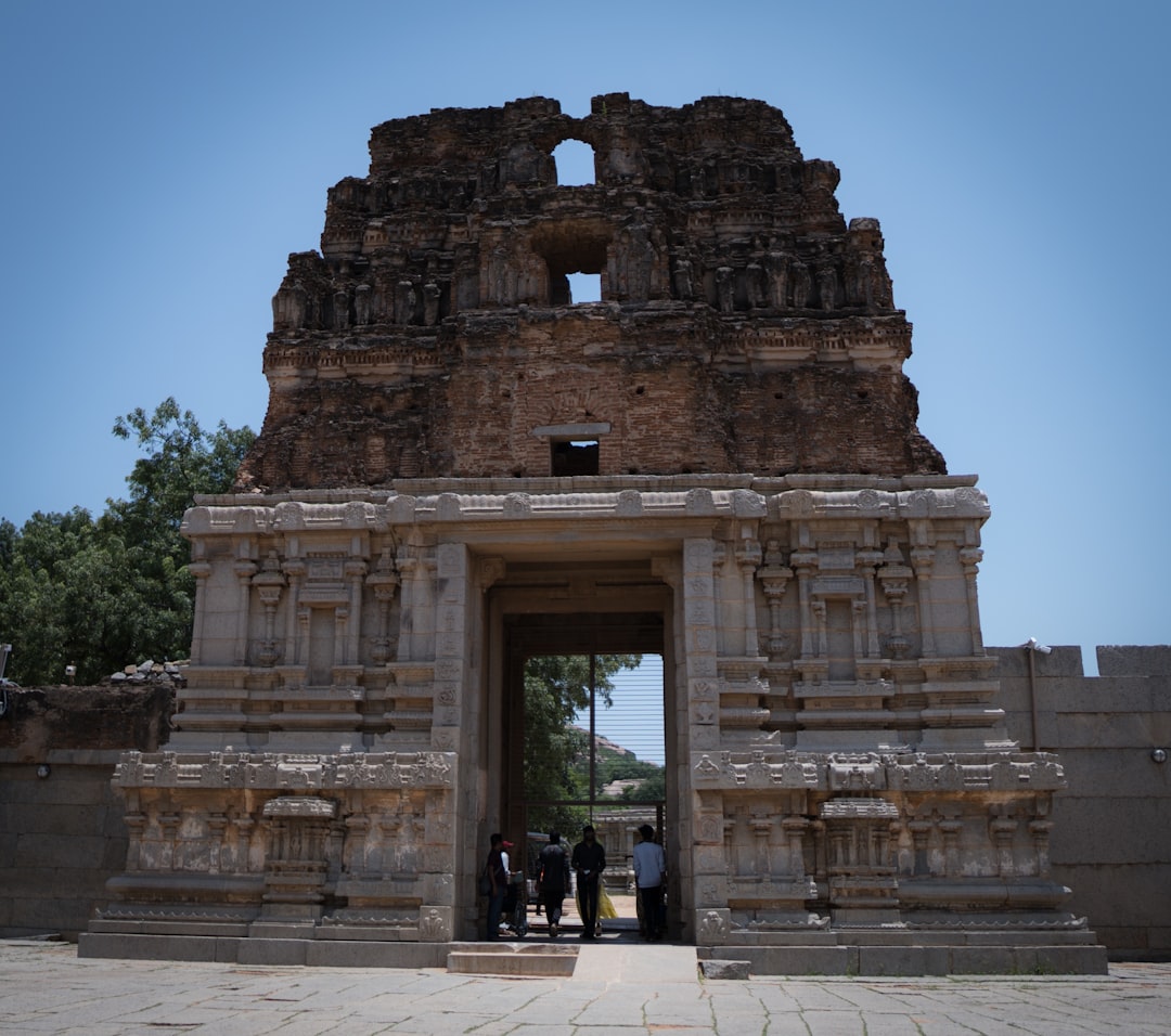 a group of people standing in front of a stone structure